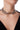 Choker BLKMBA con cadena gruesa plateada y charm ovalado con detalle de mapa mundial.