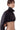 Chaqueta corta de cuero negro BLKMBA con cuello alto y diseño ajustado en la cintura.